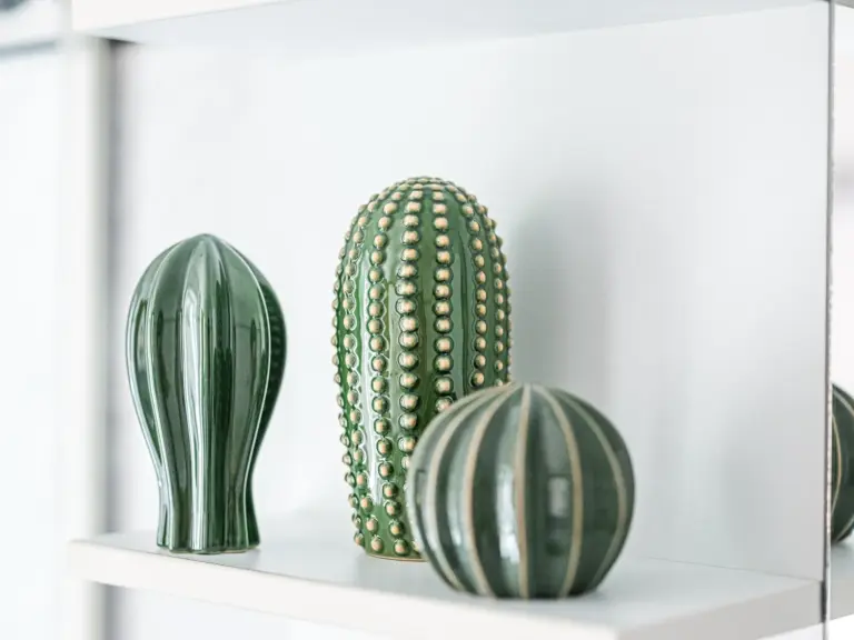 Green decorative accents in the bathroom at EMERALD GROVE